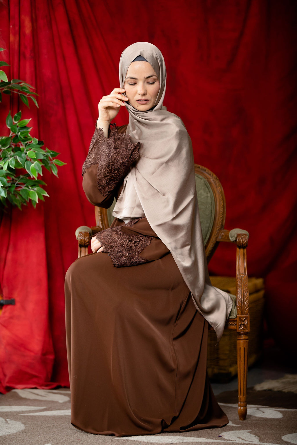 Woman in brown hijab and lace sleeve zipper abaya dress