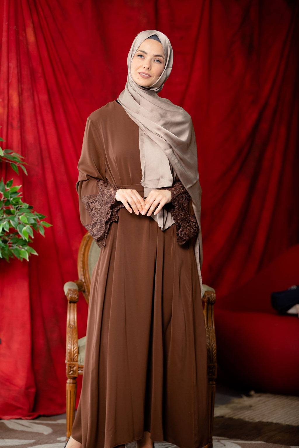Woman in brown abaya hijab wearing coffee lace sleeve front zipper dress