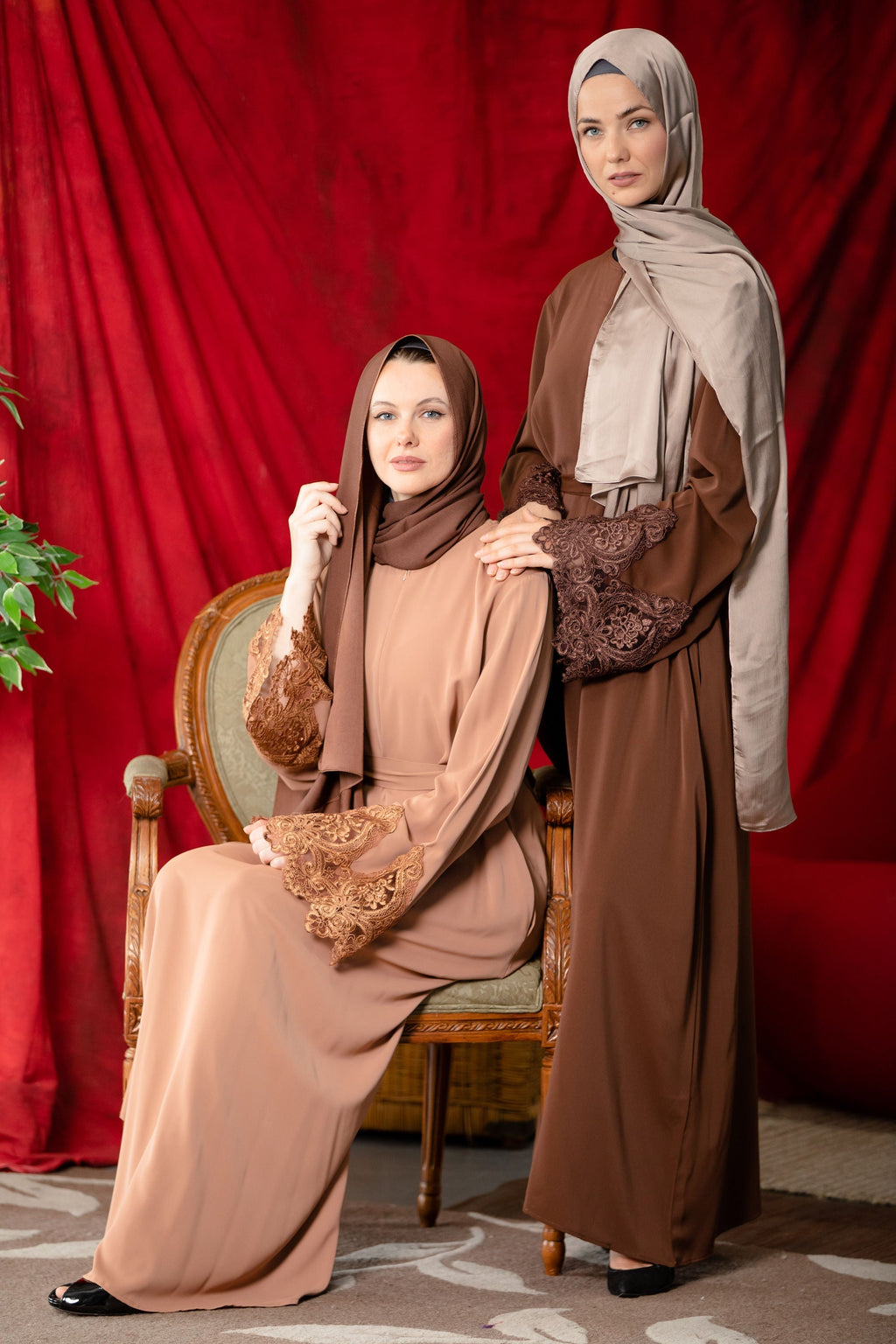 Two women in modest coffee lace sleeve abaya dresses with headscarves