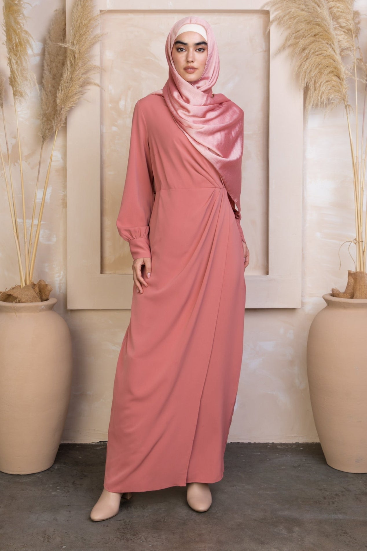 Woman in pink draped maxi dress and matching hijab on clearance