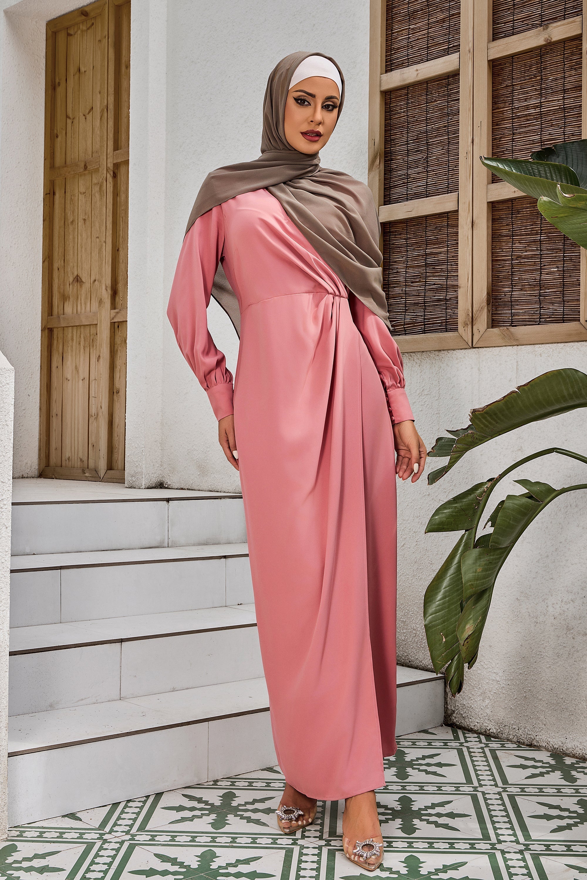 Woman in pink long-sleeved hijab and Coral Wrap Maxi Dress on clearance