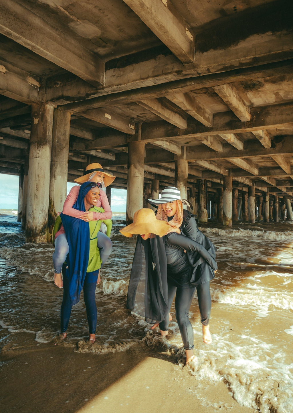 Women in lime green modest swimsuit giving piggyback rides on beach