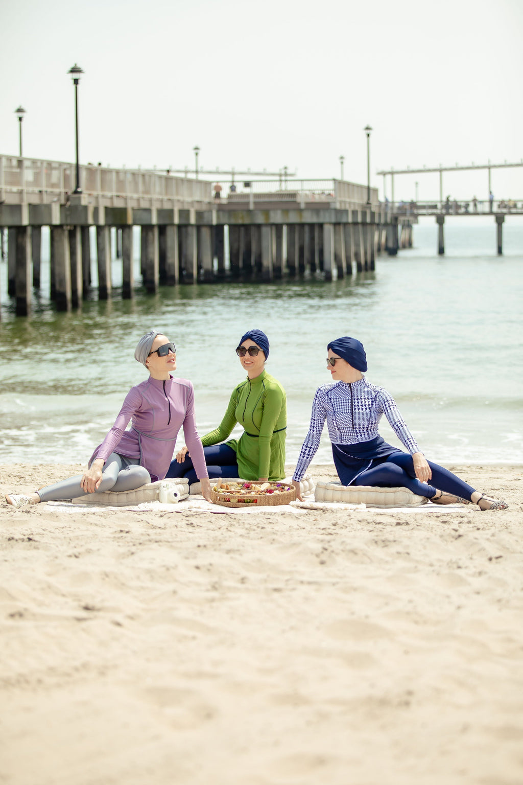 Three women wearing lime green 3-piece modest burkini swimsuits