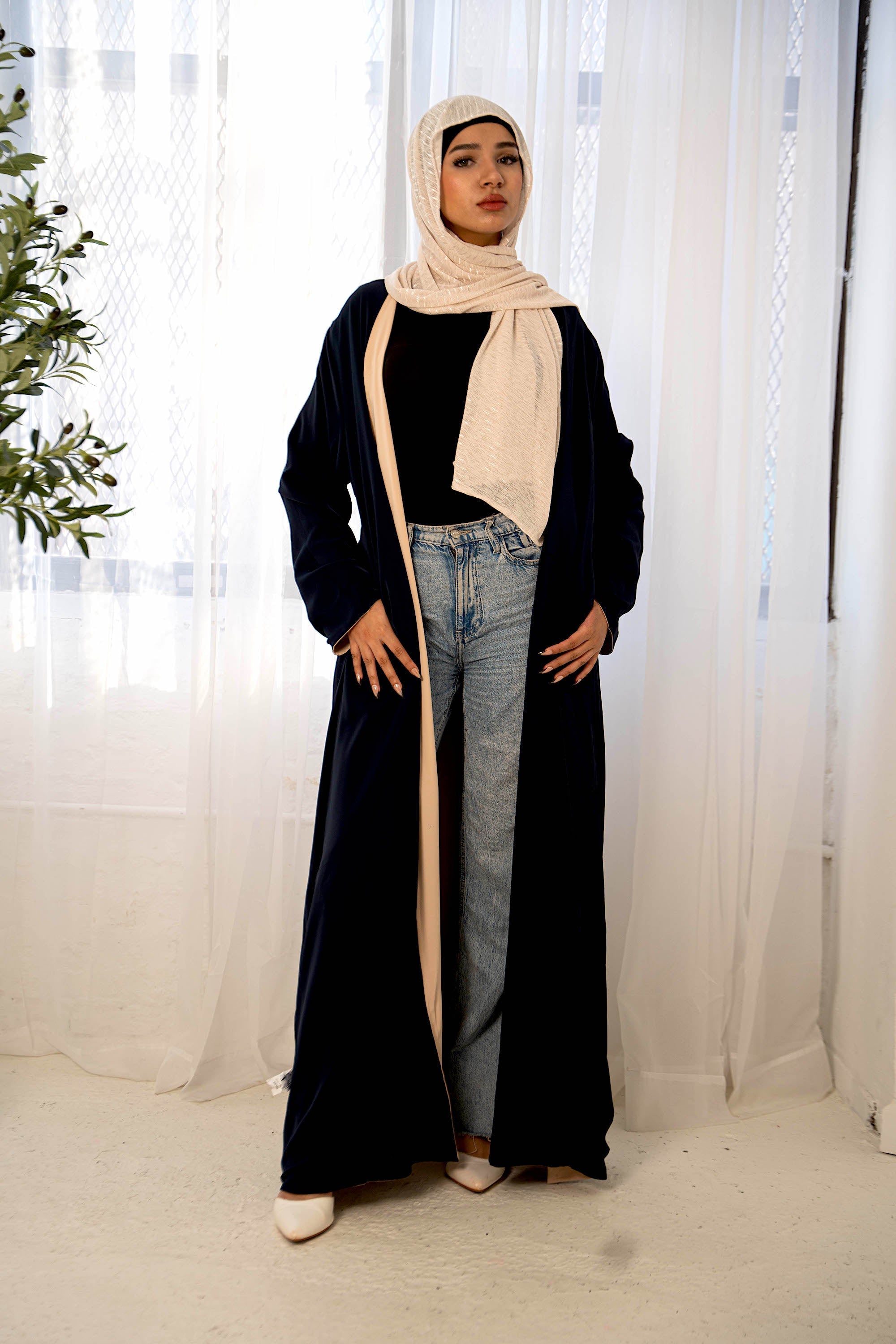 Woman in navy and cream reversible open abaya hijab coat