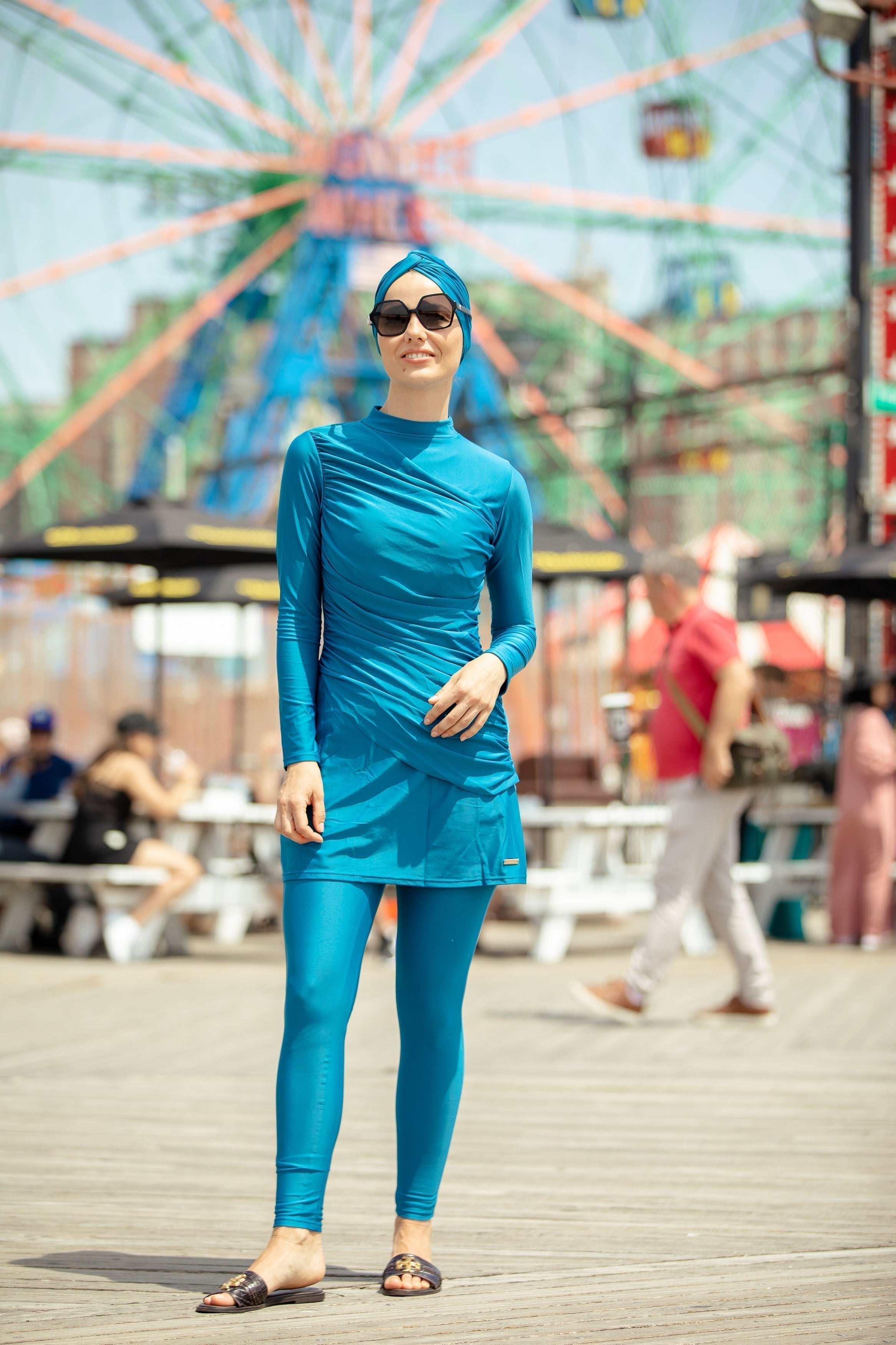 Woman in blue ruched 3-piece modest burkini swimsuit