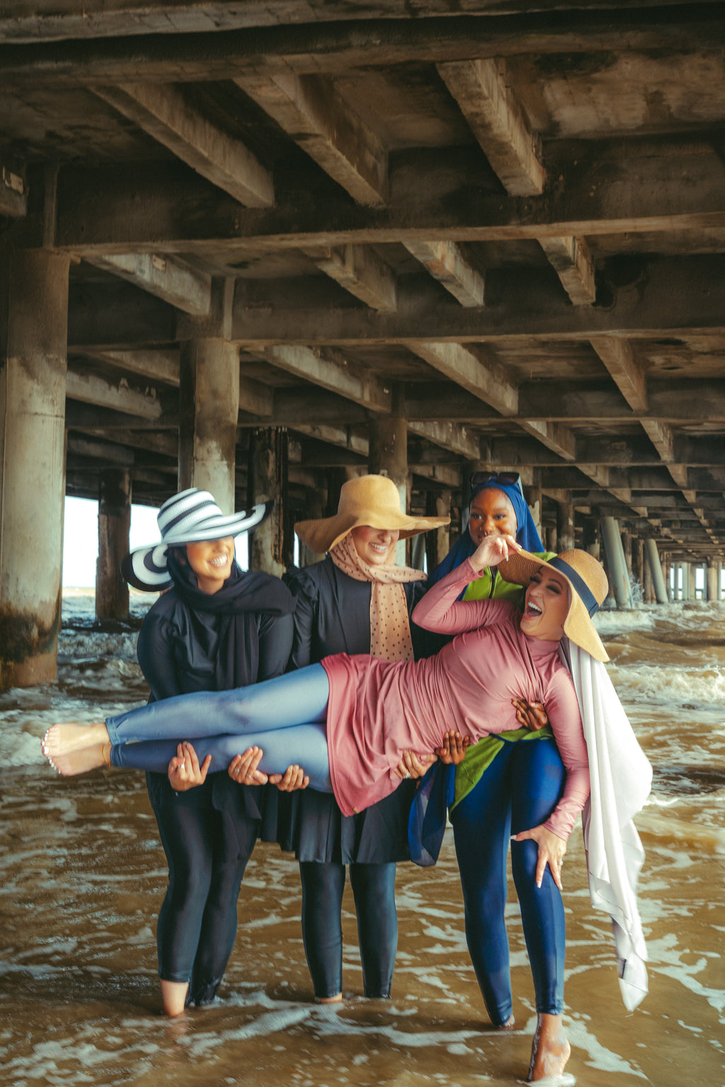 Four women modeling ruched 3-piece modest swimsuit on clearance